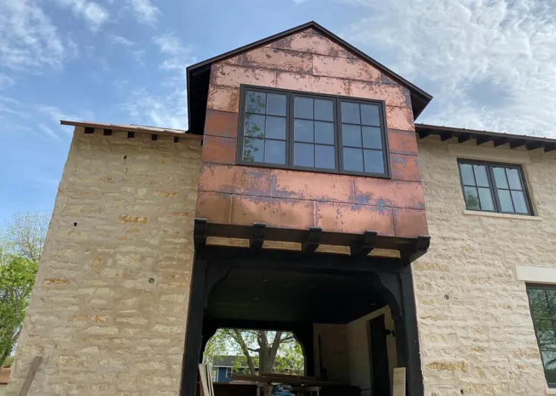 Copper metal panel facade on a stone building for Roof Repair in Pflugerville