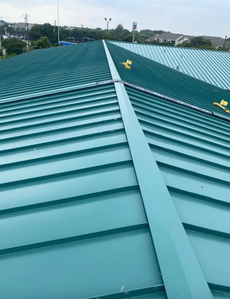 Green commercial metal roof ridge and valley for Metal Roof Repair in Pflugerville