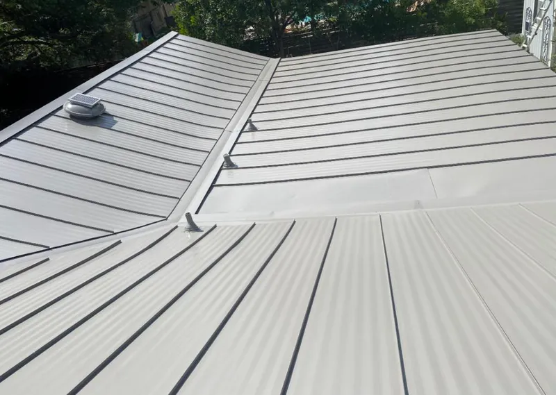 Solar attic fan installed on a metal roof for Roof Ventilation in Pflugerville